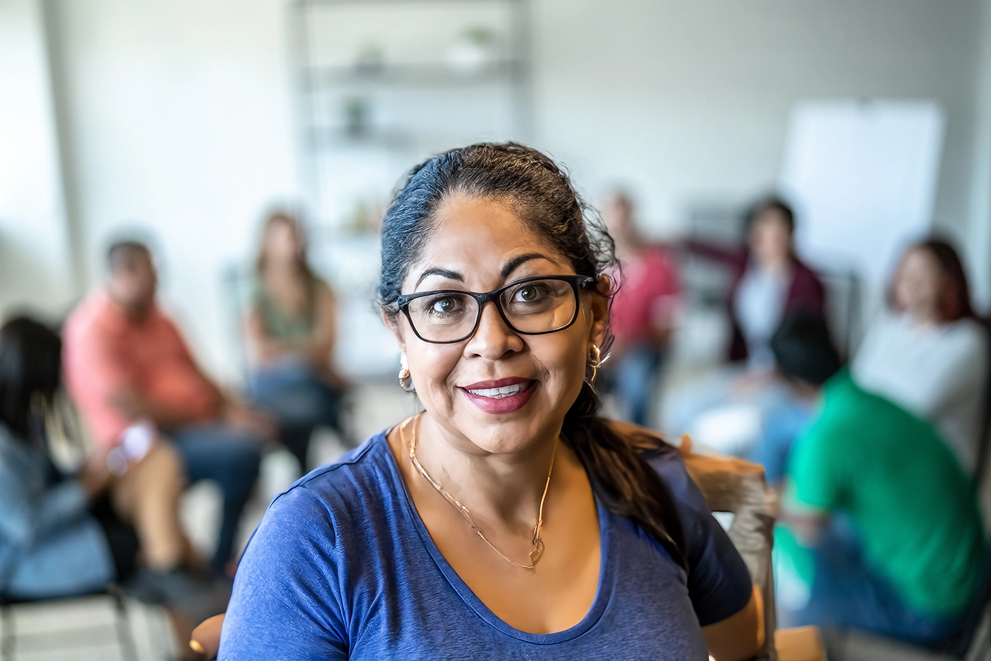 Group Therapy woman smiling in foreground